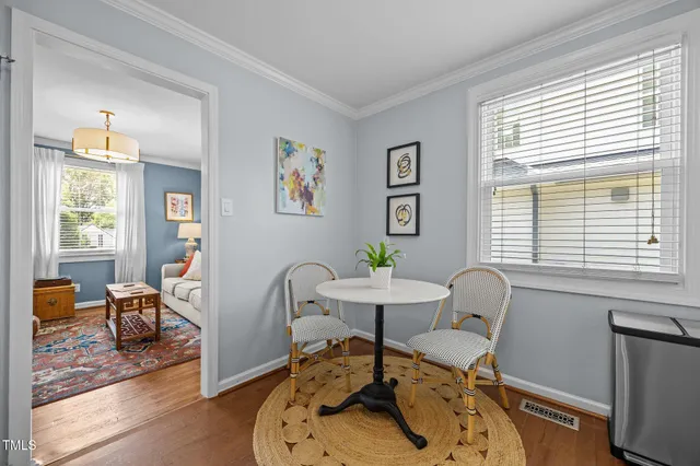 a dining room with furniture a chandelier and wooden floor