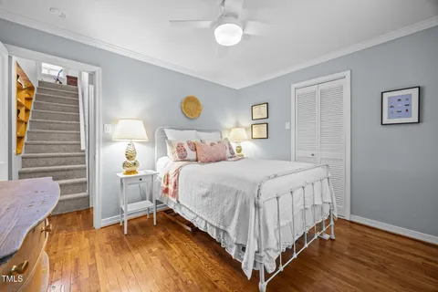 a view of staircase with lots of frames on wall and a large window