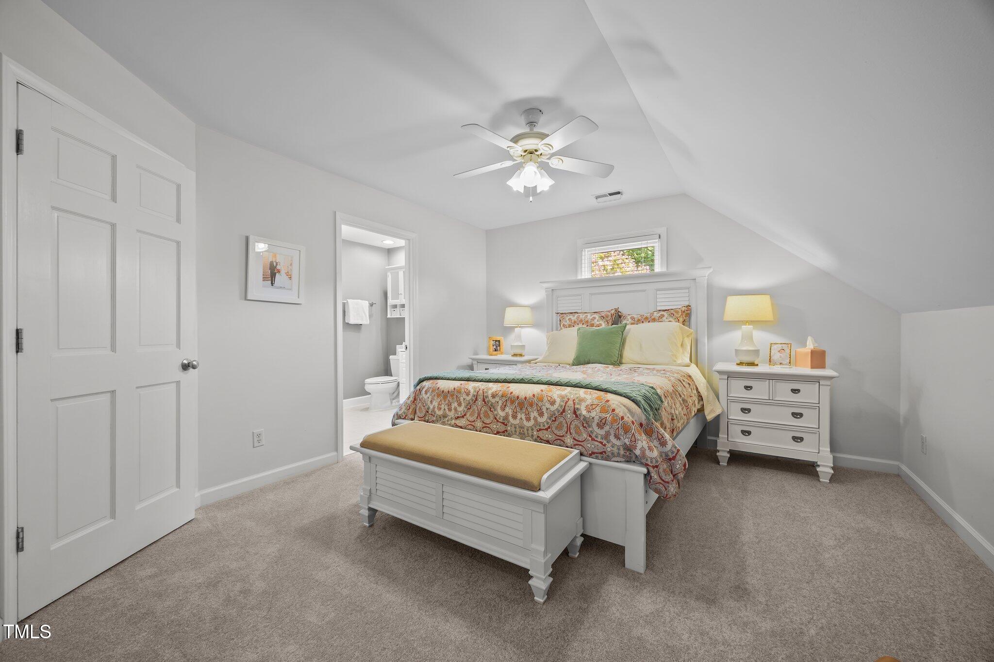 711 New Road Raleigh, NC 27608 - Photo 28 of 54 a bedroom with a bed and a chandelier