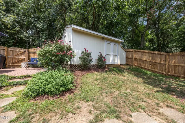 a view of a patio with table and chairs under an umbrella
