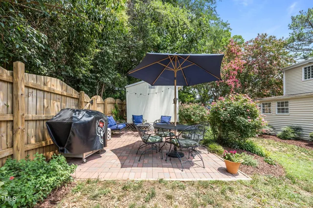 a view of a house with backyard sitting area and garden