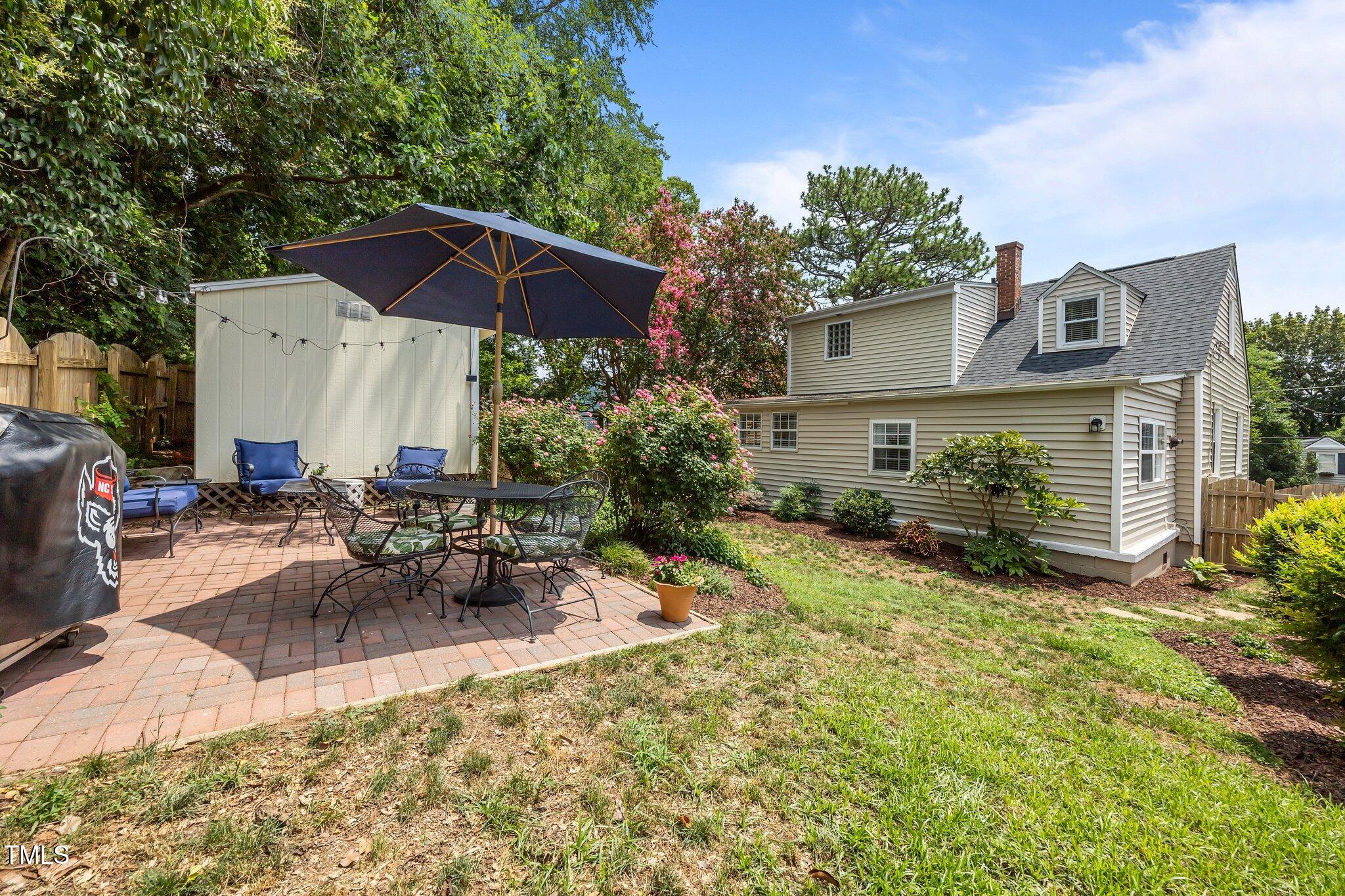 711 New Road Raleigh, NC 27608 - Photo 39 of 54 a view of a house with backyard sitting area and garden