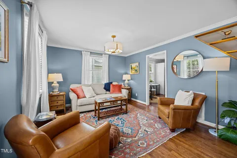 a living room with furniture a rug and a window