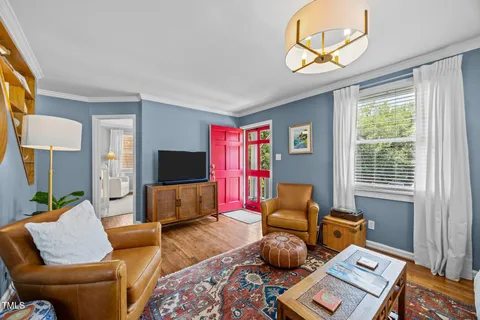 a living room with furniture and a chandelier