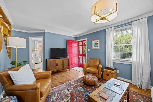 a living room with furniture and a chandelier
