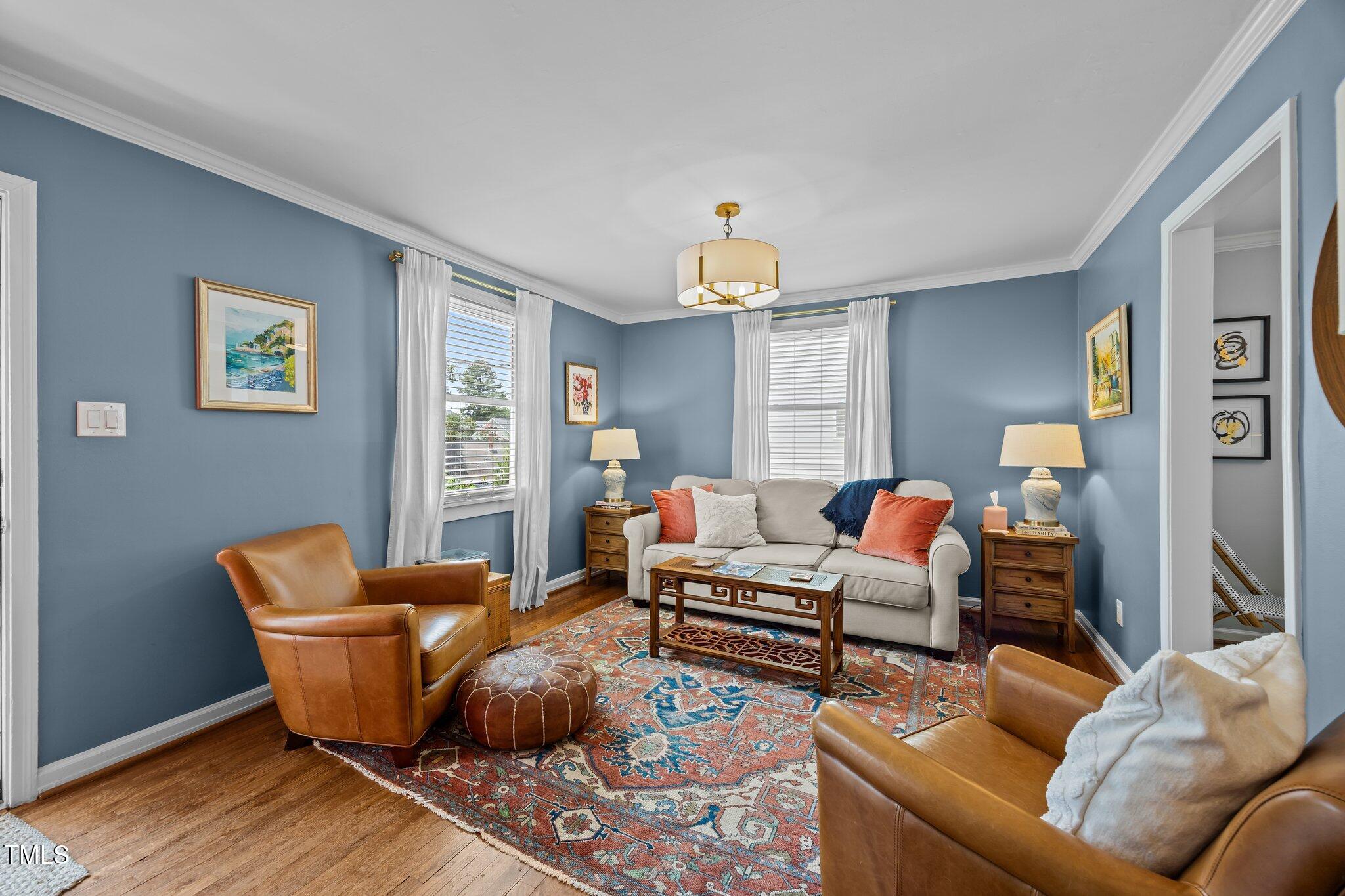 711 New Road Raleigh, NC 27608 - Photo 8 of 54 a living room with furniture and a chandelier