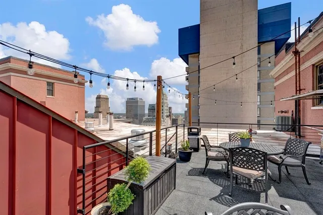 a view of a terrace with lawn chairs