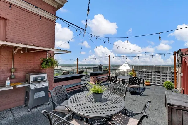 a view of a patio with a table and chairs