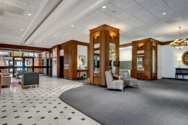 a living room with furniture and large windows