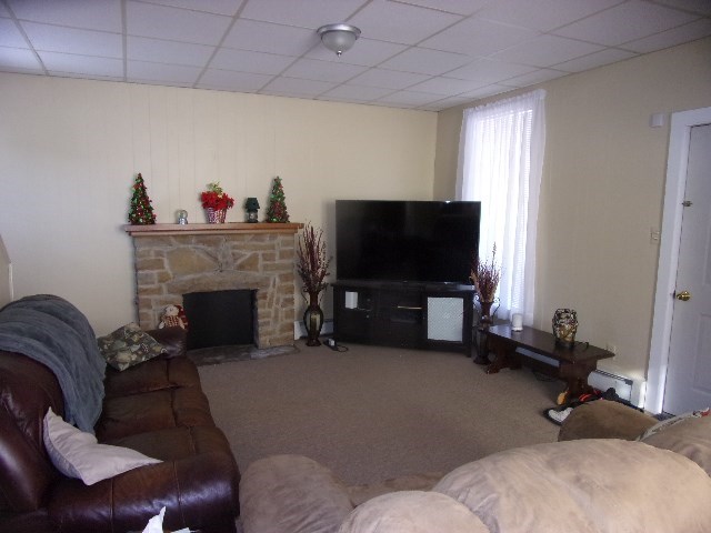 149 Madison Road Clarion, PA 16214 - Photo 36 of 39 a living room with furniture a flat screen tv and a fireplace