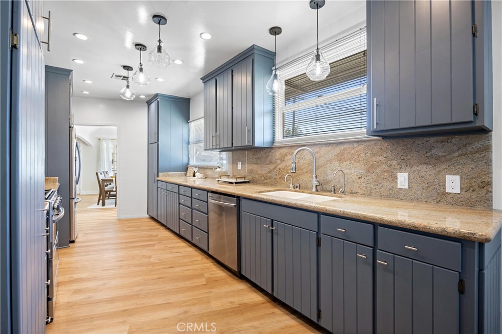 1049 Second Street Norco, CA 92860 - Photo 12 of 66 a kitchen with stainless steel appliances kitchen island granite countertop a sink and cabinets