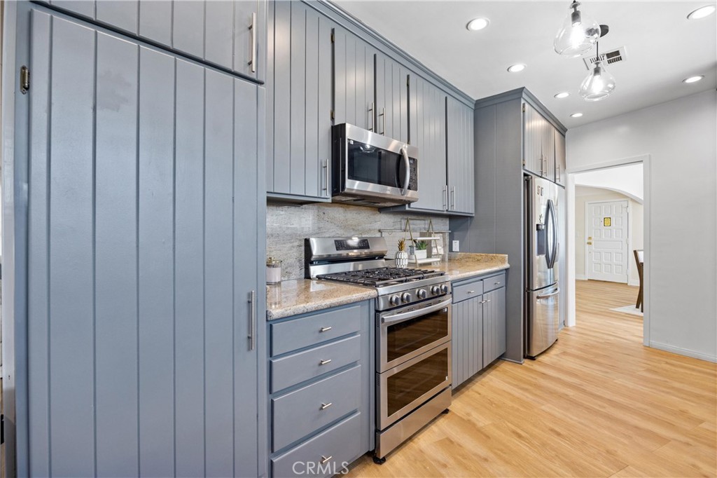 1049 Second Street Norco, CA 92860 - Photo 13 of 66 a kitchen with stainless steel appliances granite countertop a refrigerator stove and sink