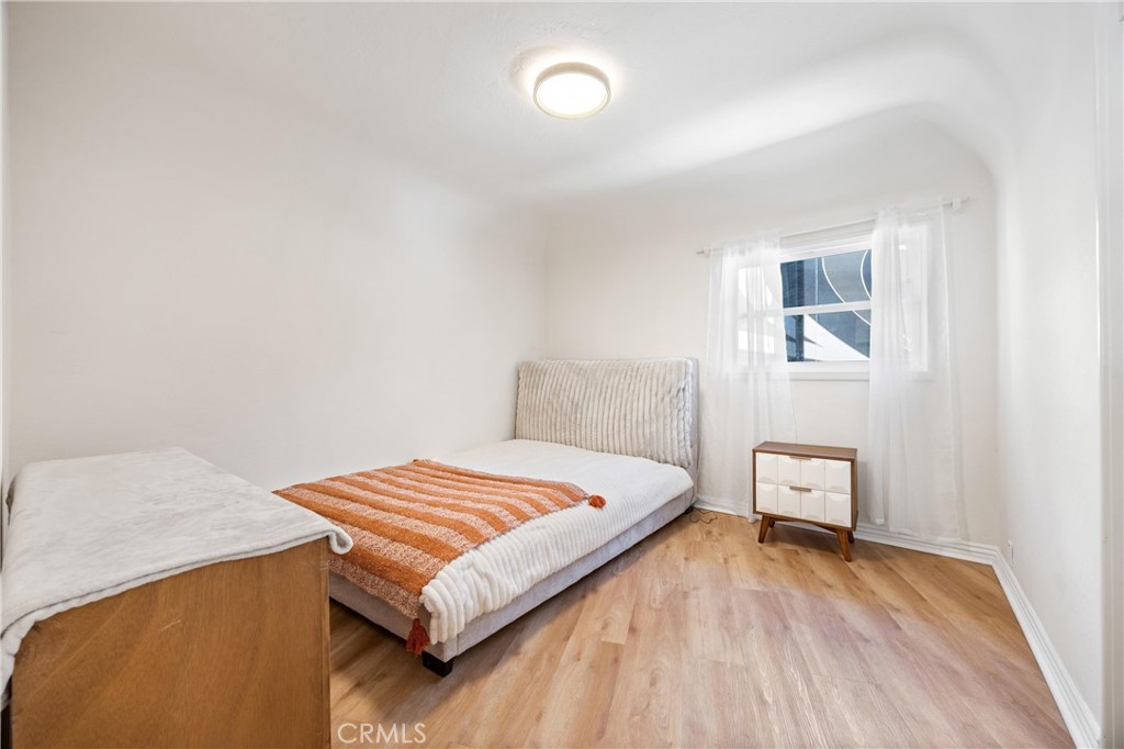 1049 Second Street Norco, CA 92860 - Photo 32 of 66 a bedroom with a bed and wooden floor