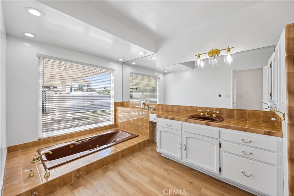 1049 Second Street Norco, CA 92860 - Photo 34 of 66 a spacious bathroom with a granite countertop sink mirror and a