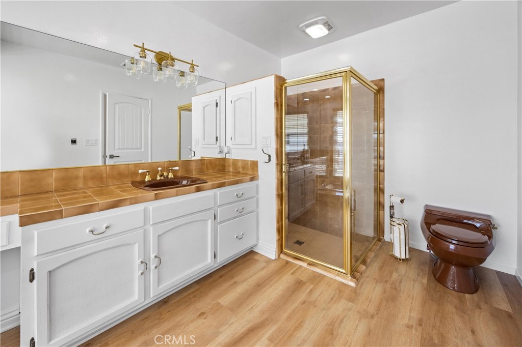 1049 Second Street Norco, CA 92860 - Photo 35 of 66 a spacious bathroom with a granite countertop sink a mirror and shower