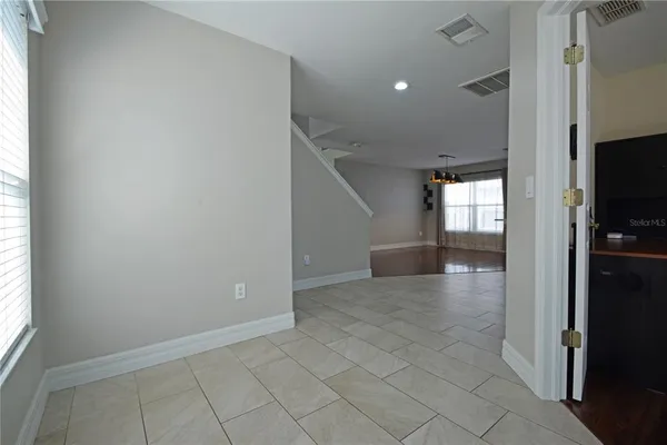 a view of a hallway to rooms and stairs