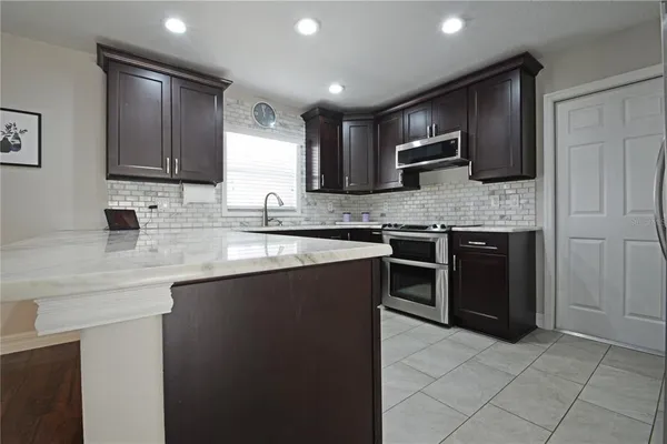 a kitchen with a sink stove and cabinets