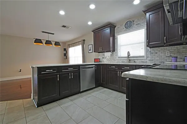 a kitchen with a sink a stove and cabinets