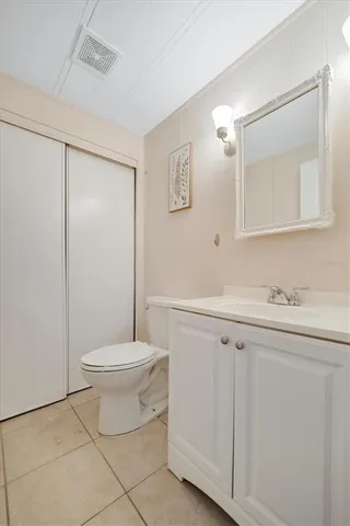 a bathroom with a sink a toilet and mirror
