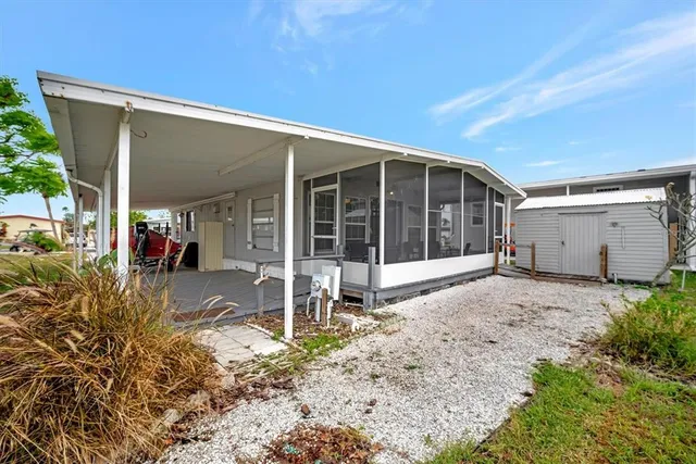 a view of a porch with wooden floor and a yard