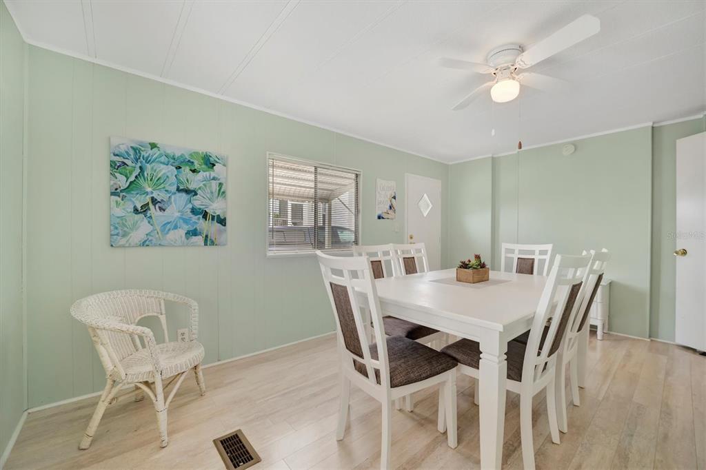 110 East St Lucia Loop Apollo Beach, FL 33572 - Photo 10 of 35 a view of a dining room with furniture and wooden floor