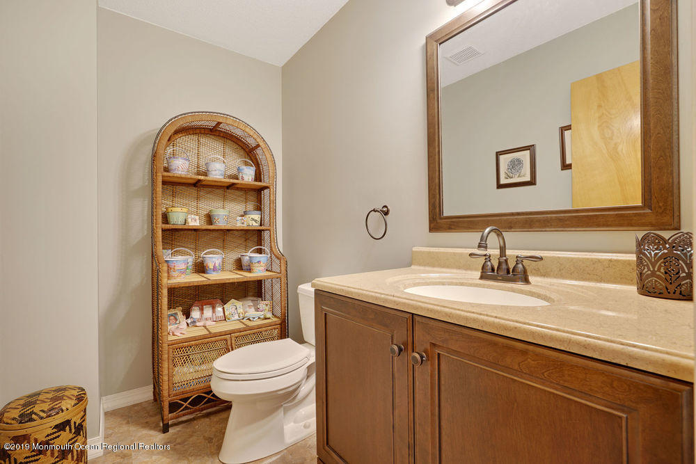 205 Forge Road West Creek, NJ 08092 - Photo 29 of 64 a bathroom with a toilet a sink and mirror