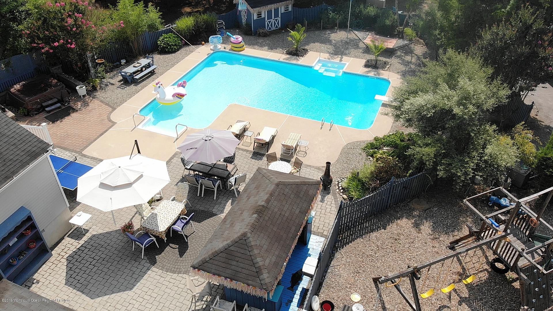 205 Forge Road West Creek, NJ 08092 - Photo 3 of 64 an aerial view of a swimming pool with outdoor seating