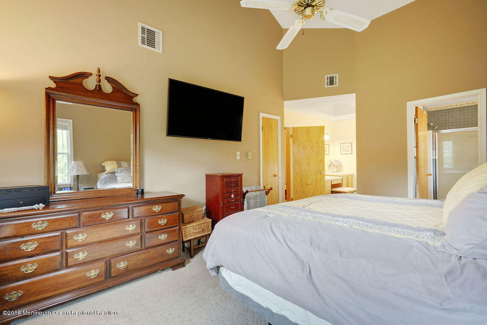 205 Forge Road West Creek, NJ 08092 - Photo 32 of 64 a bedroom with a bed and a flat tv screen on dresser