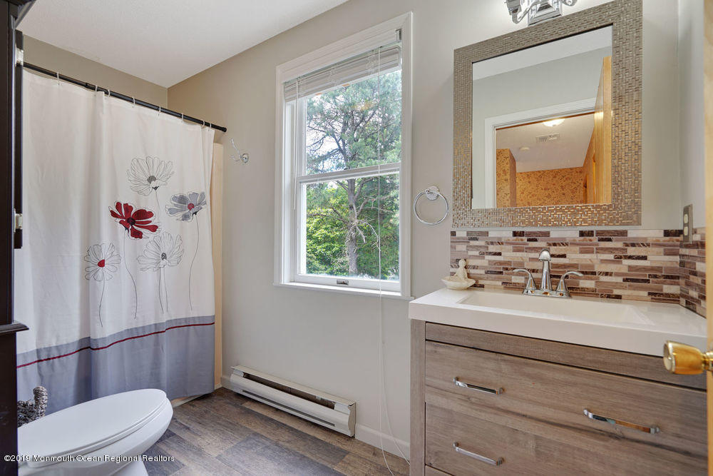 205 Forge Road West Creek, NJ 08092 - Photo 35 of 64 a bathroom with a sink a toilet and a window