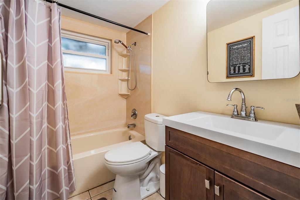 3608 Umber Road Holiday, FL 34691 - Photo 12 of 20 a bathroom with a sink a toilet and shower