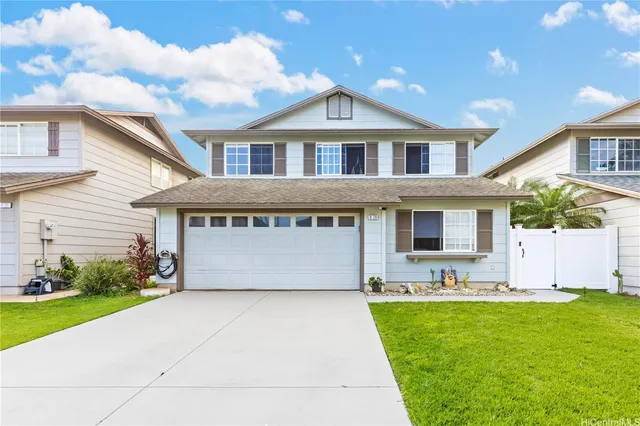 a front view of house with yard and outdoor seating