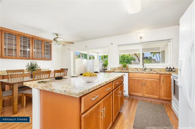 a kitchen with stainless steel appliances granite countertop a sink stove and cabinets