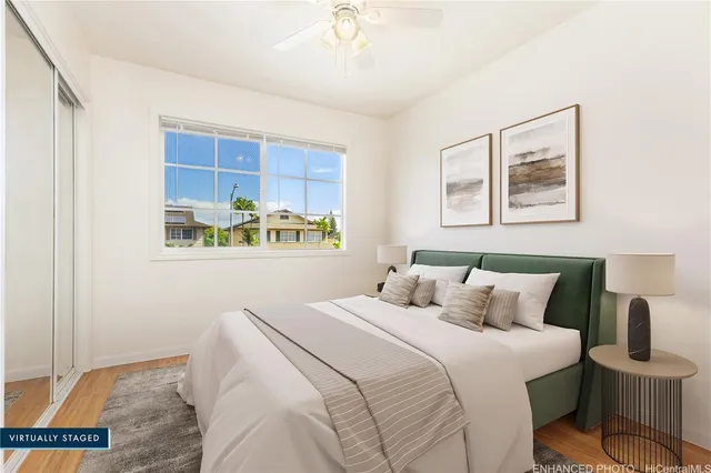 a bedroom with a bed and a painting on the wall