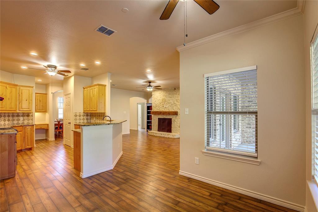 2617 Kirby Road Rowlett, TX 75088 - Photo 39 of 39 Kitchen featuring arched walkways, a peninsula, backsplash, open floor plan, and a ceiling fan