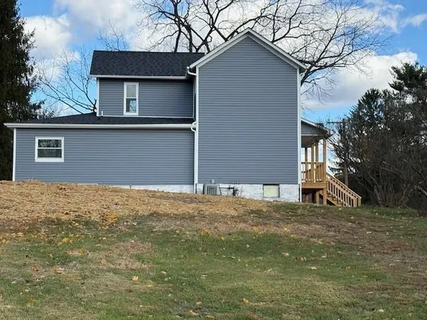 a house that has a tree in front of it