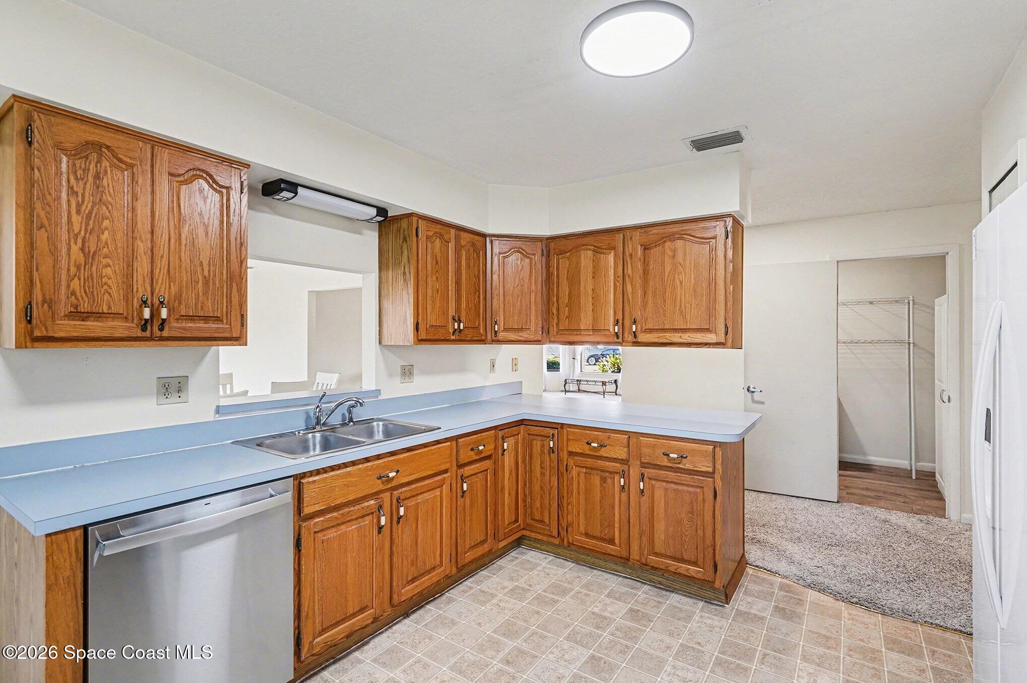 1741 Freedom Drive Melbourne, FL 32940 - Photo 11 of 37 a kitchen with a sink cabinets and window