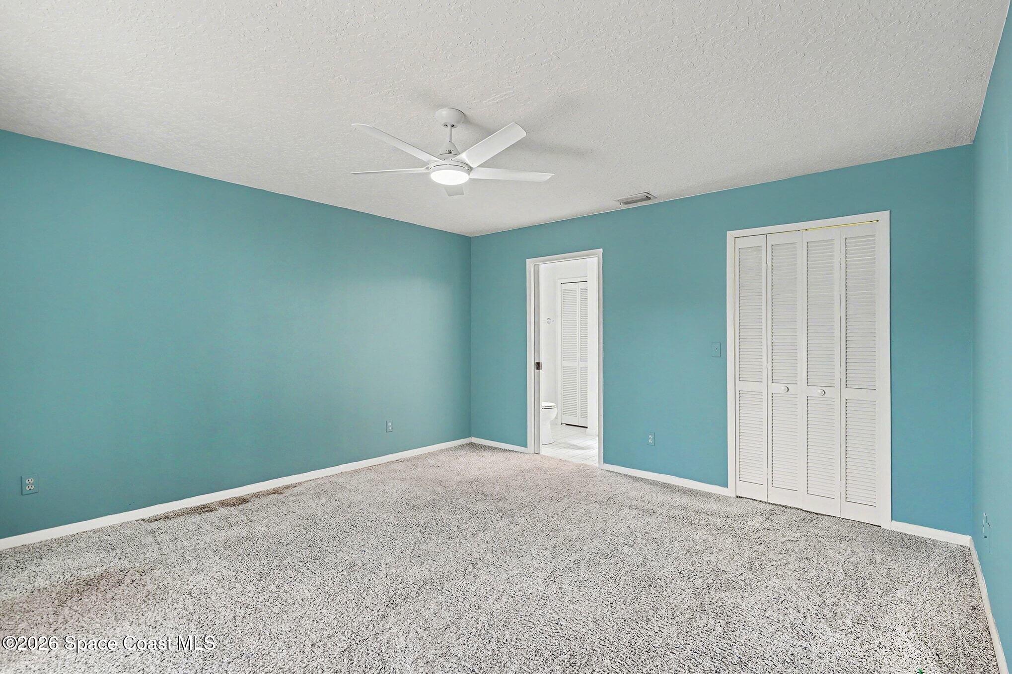 1741 Freedom Drive Melbourne, FL 32940 - Photo 15 of 37 an empty room with closet and fan