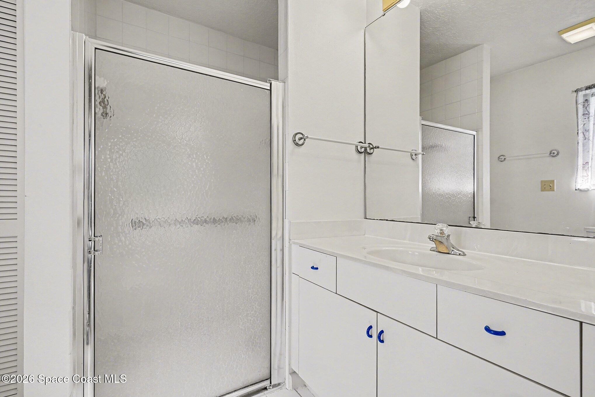 1741 Freedom Drive Melbourne, FL 32940 - Photo 18 of 37 a bathroom with a shower sink and vanity