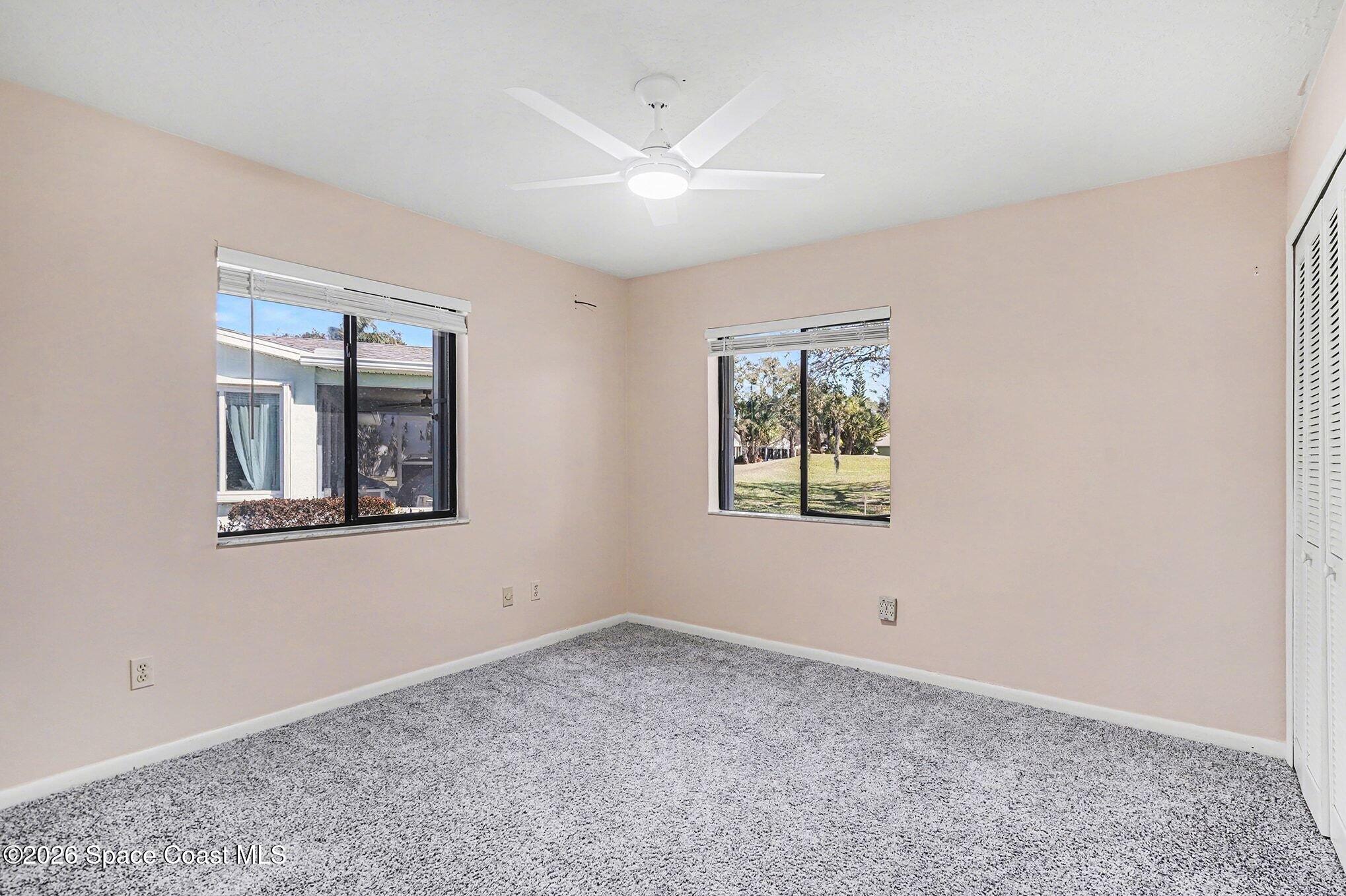 1741 Freedom Drive Melbourne, FL 32940 - Photo 19 of 37 a view of an empty room with window and closet
