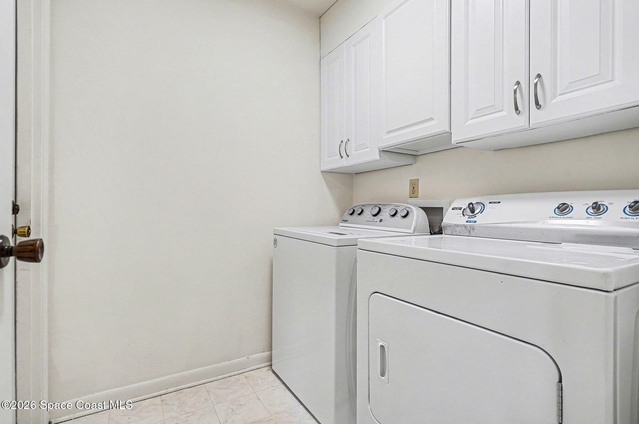 1741 Freedom Drive Melbourne, FL 32940 - Photo 22 of 37 a utility room with dryer and washer