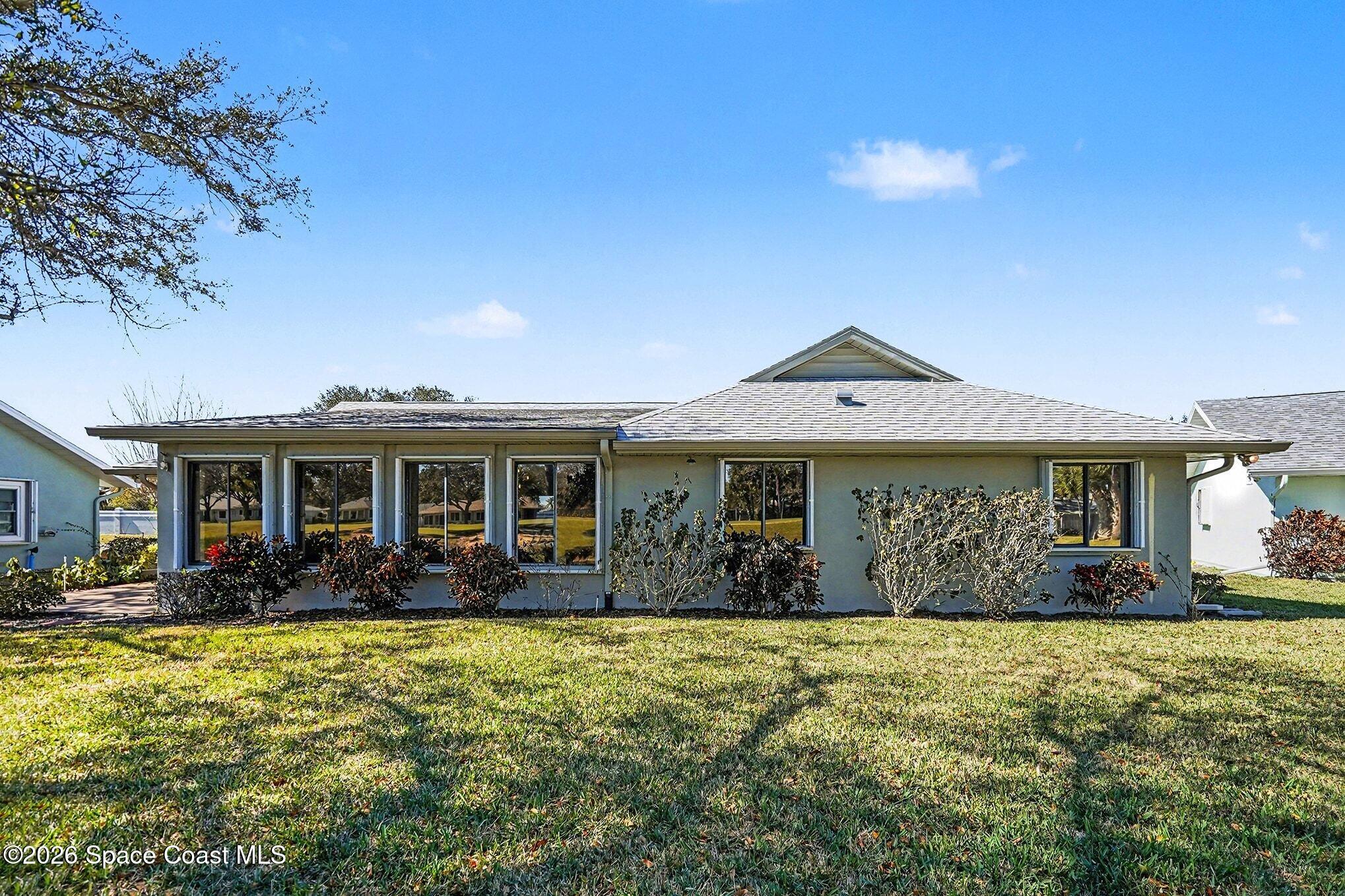 1741 Freedom Drive Melbourne, FL 32940 - Photo 24 of 37 a front view of a house with garden