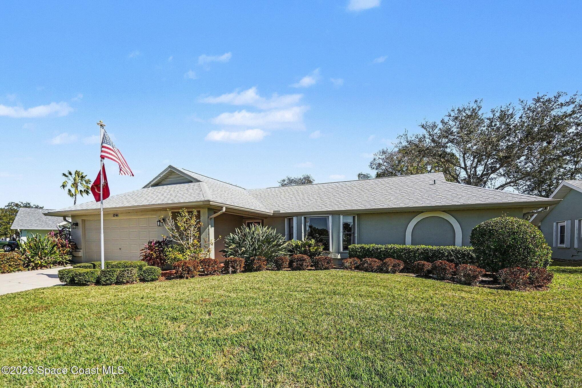 1741 Freedom Drive Melbourne, FL 32940 - Photo 4 of 37 a front view of a house with garden