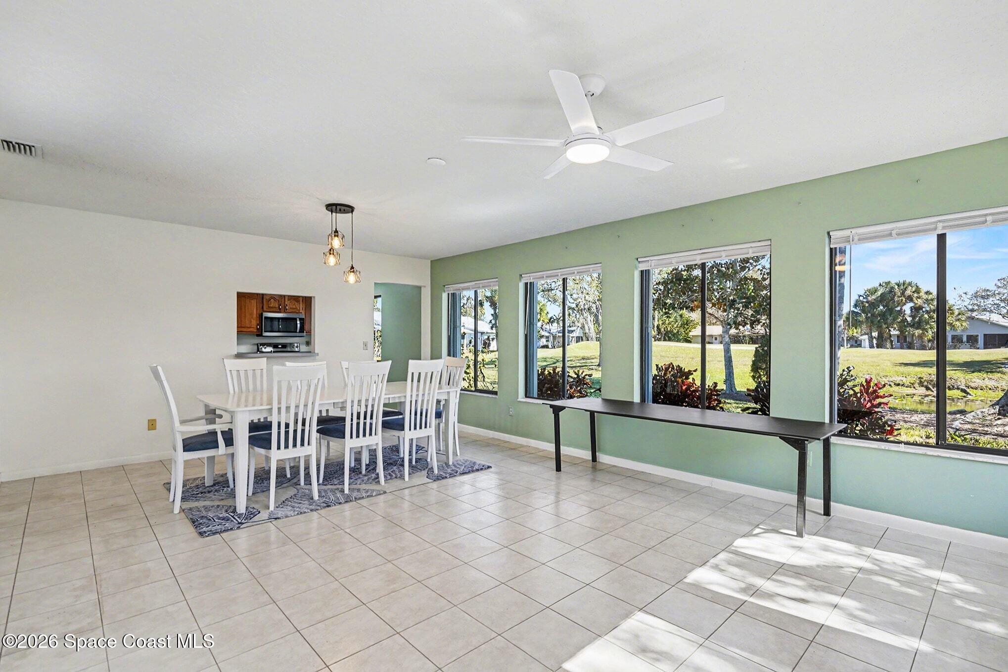 1741 Freedom Drive Melbourne, FL 32940 - Photo 8 of 37 a dining room with furniture and a floor to ceiling window