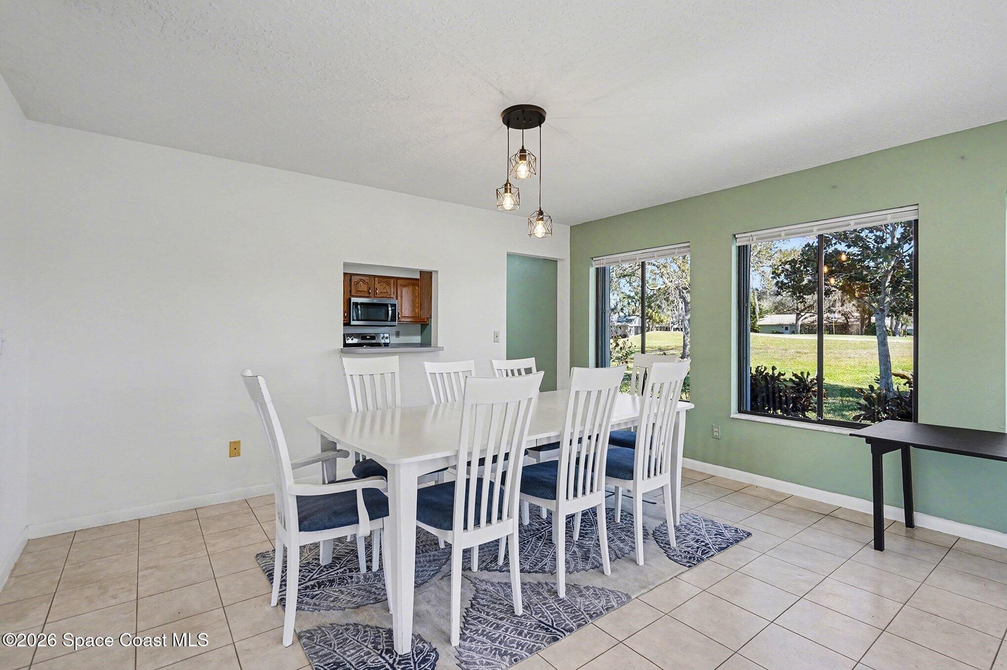 1741 Freedom Drive Melbourne, FL 32940 - Photo 10 of 37 a view of a dining room with furniture window and outside view