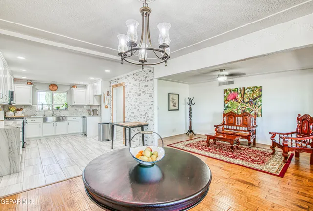 a bedroom with a bed and a dresser with wooden floor