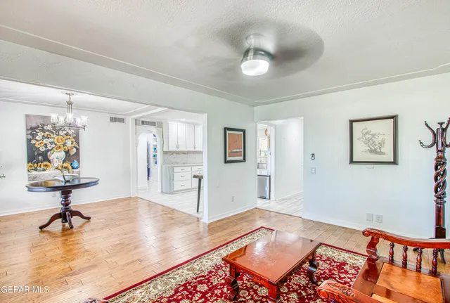 a bedroom with a bed and a chandelier
