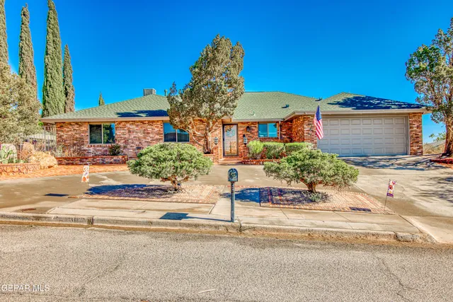 a kitchen with stainless steel appliances kitchen island a chandelier in it and living room view