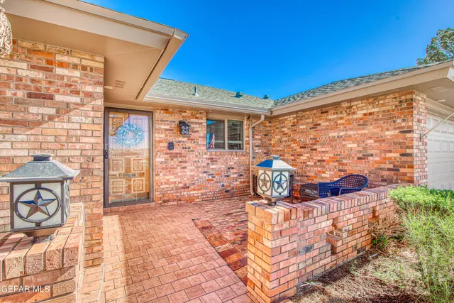 a kitchen with granite countertop white cabinets stainless steel appliances and a sink