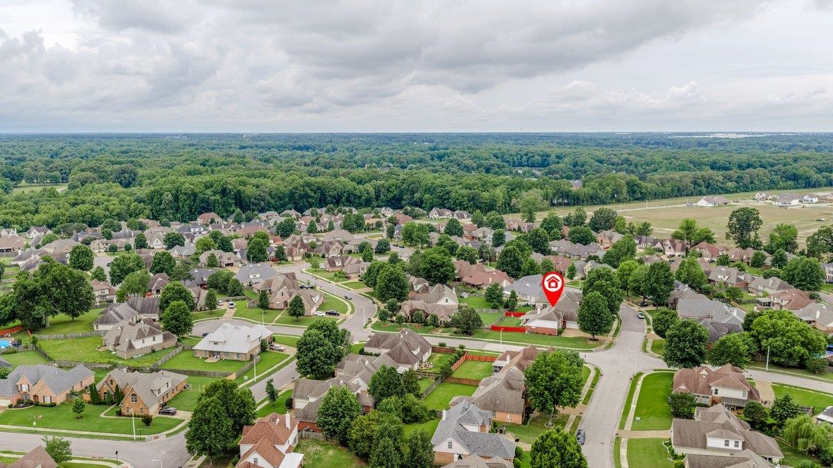 4840 Rainy Pass Road Collierville, TN 38017 - Photo 3 of 30 Aerial perspective showcasing a residential neighborhood with numerous homes on individual lots, mature trees, and a backdrop of dense woodland