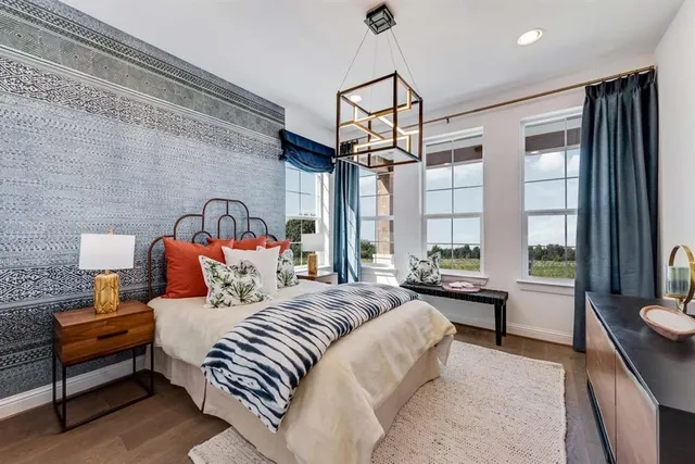 a bedroom with a bed a flat screen tv and a couch